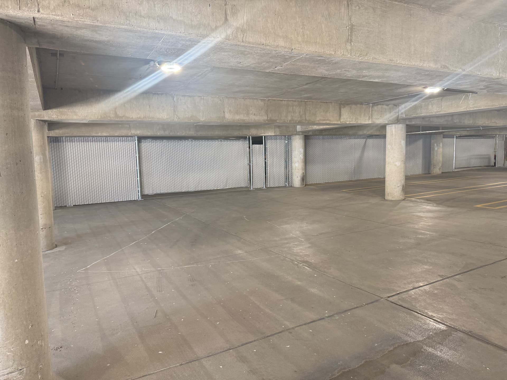 Chain link storage enclosure inside a Utah parking garage